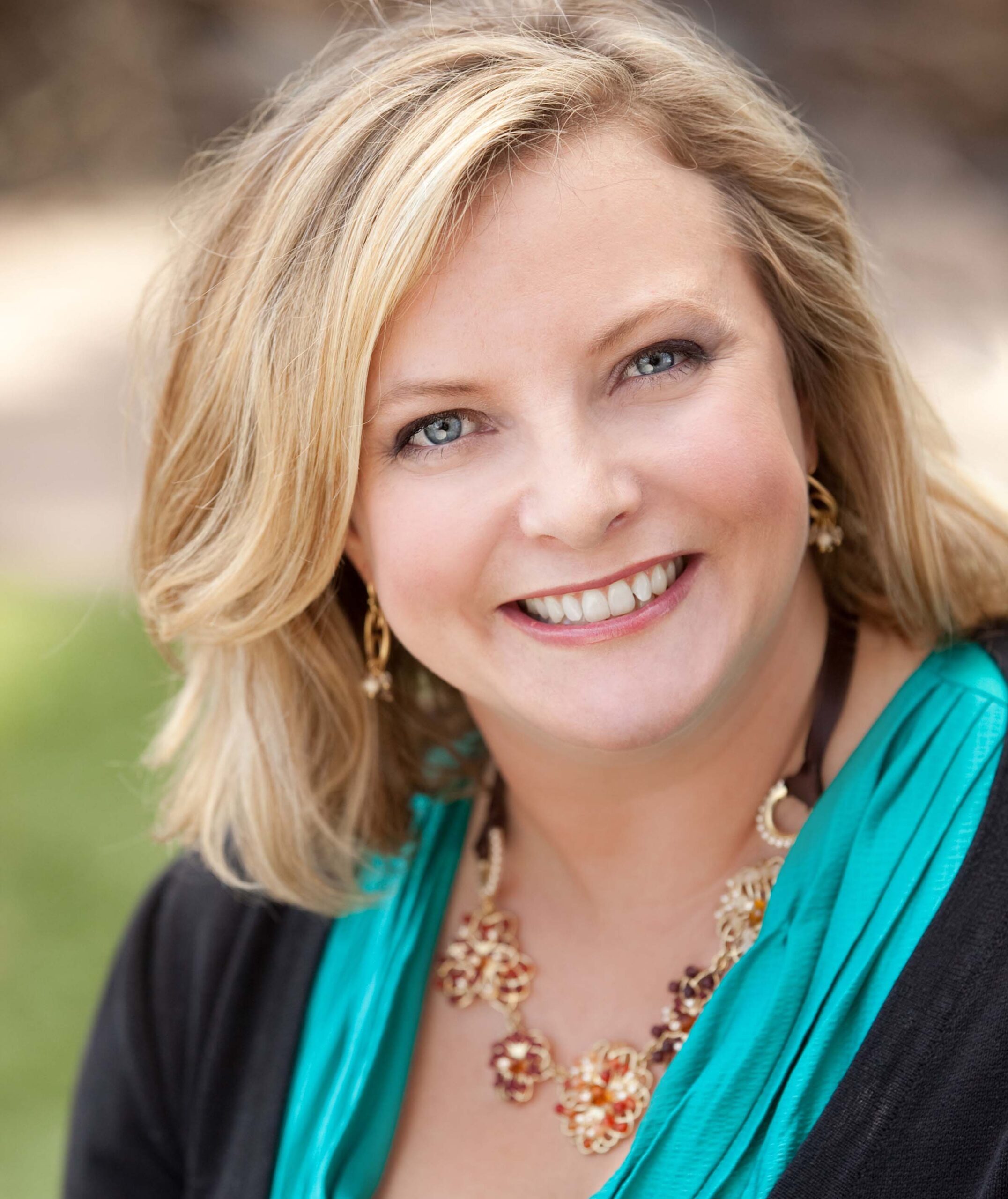 Angela in a Black and Teal Color Top Headshot One